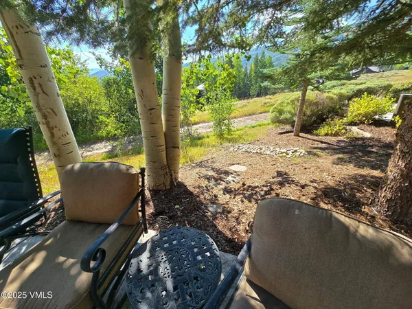 a view of a yard with chairs