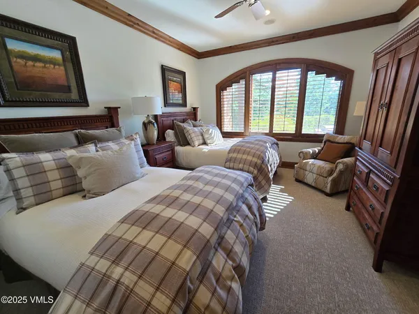 a bed room with two beds and a large window