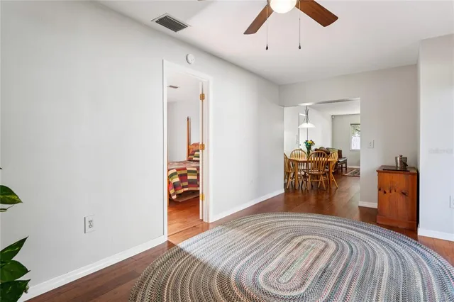 a view of a bedroom with furniture and a ceiling fan