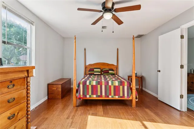 a view of a hallway with wooden floor and closet