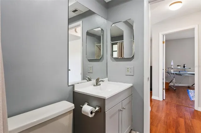 a workspace with wooden floor and a window