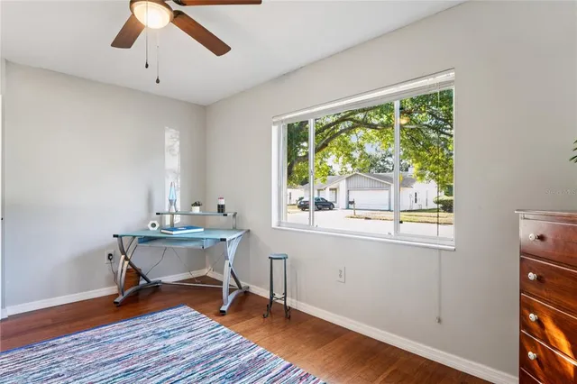 a view of a patio with table and chairs under an umbrella