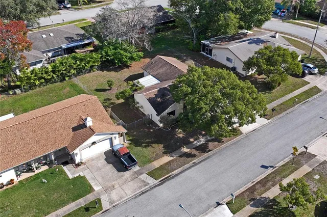 an aerial view of a houses with yard