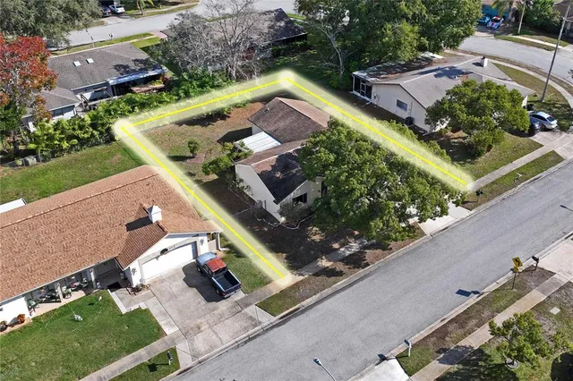 an aerial view of a house with a yard