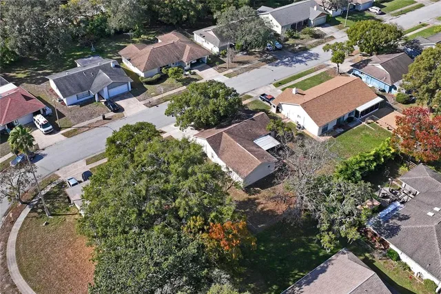an aerial view of a house with outdoor space and a fountain