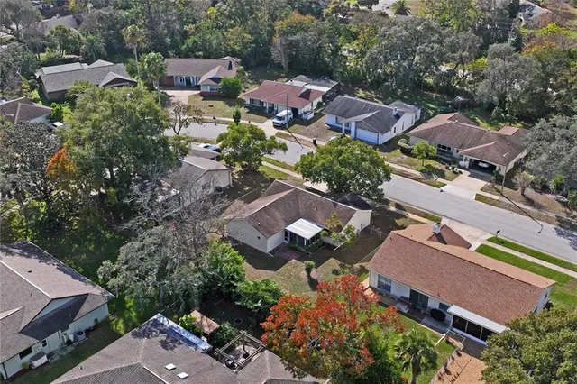 an aerial view of residential houses with city view