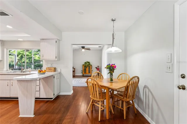 a kitchen with stainless steel appliances white cabinets a sink a stove a refrigerator and white cabinets