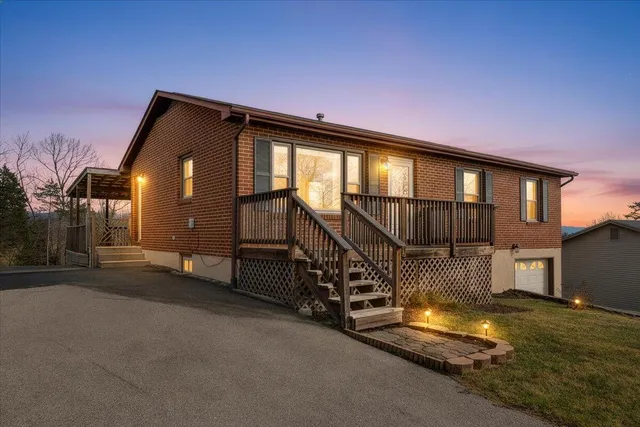 a view of an house with backyard and a tree
