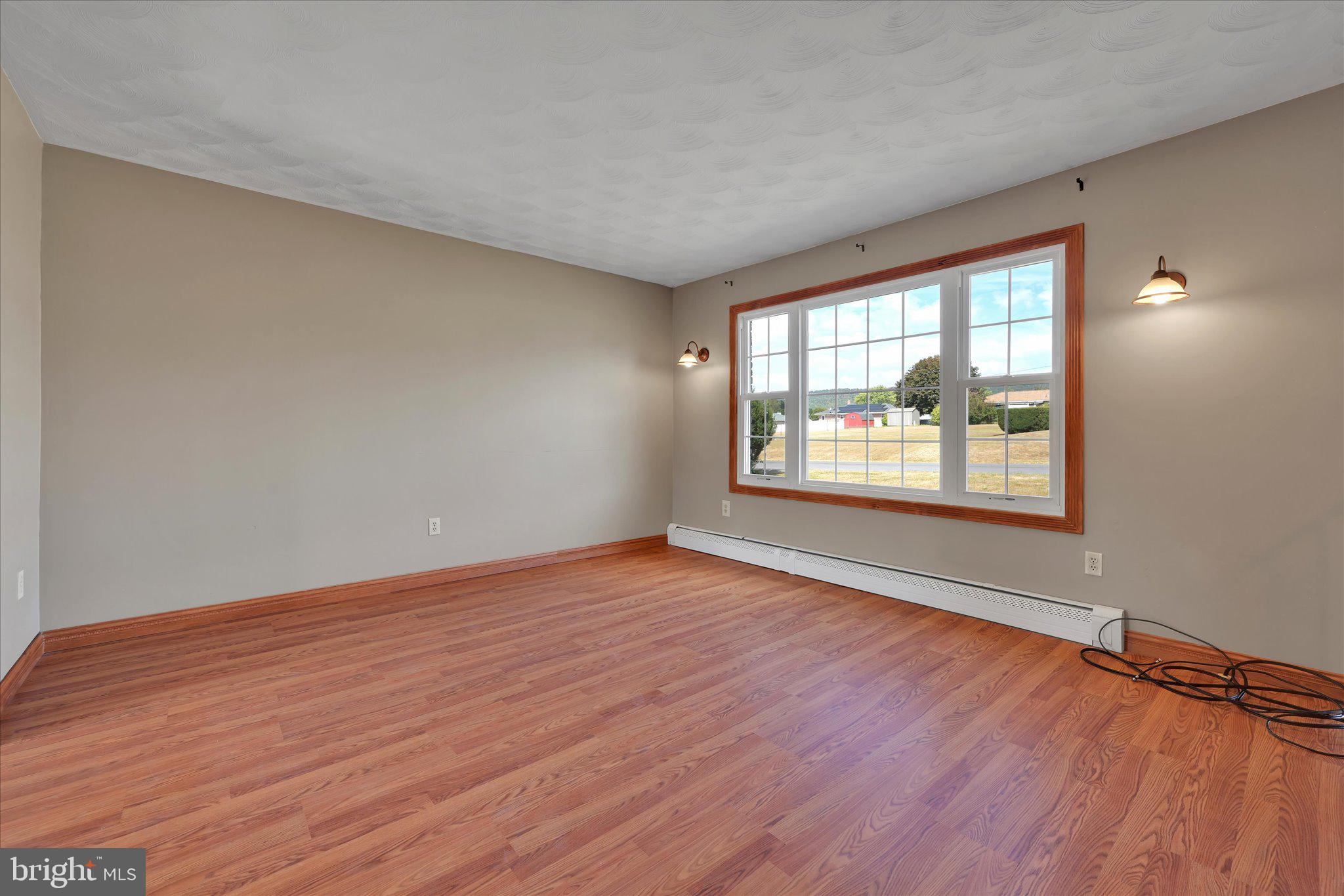 301 West Walnut Street Valley View, PA 17983 - Photo 11 of 40 an empty room with wooden floor and windows