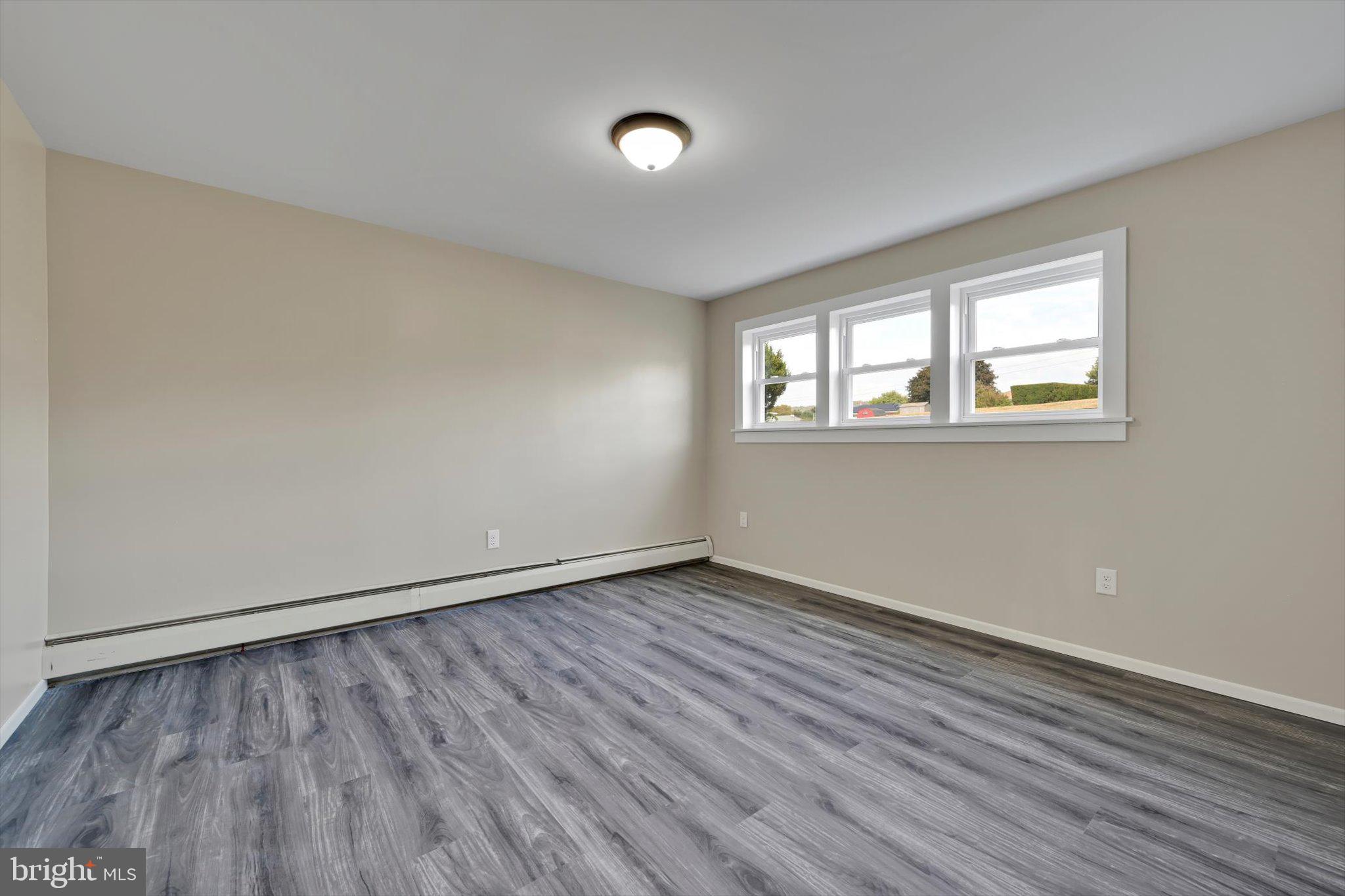 301 West Walnut Street Valley View, PA 17983 - Photo 24 of 40 an empty room with wooden floor and windows