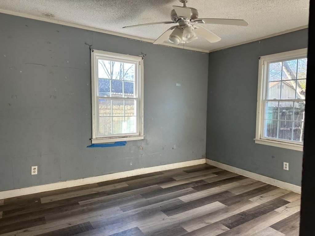 1715 Russwood Road Memphis, TN 38108 - Photo 10 of 14 Wood-finish flooring, multiple windows, ceiling fan with integrated lighting, and crown molding