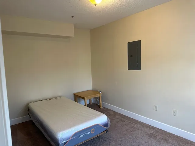 a bedroom with a bed and a table