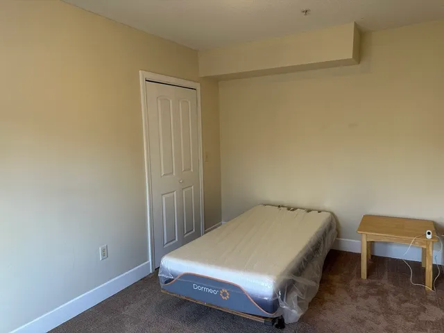 a bedroom with a bed and a table in it