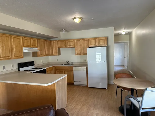 a kitchen with cabinets a sink and appliances