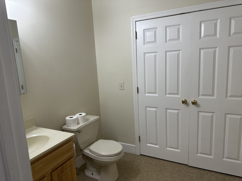 48 North Street, Unit 1 Gilbertville, MA 01031 - Photo 8 of 13 a bathroom with a sink a toilet and a mirror