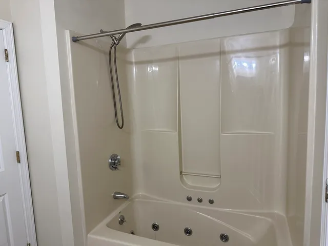 a bathroom with a shower and a bath tub