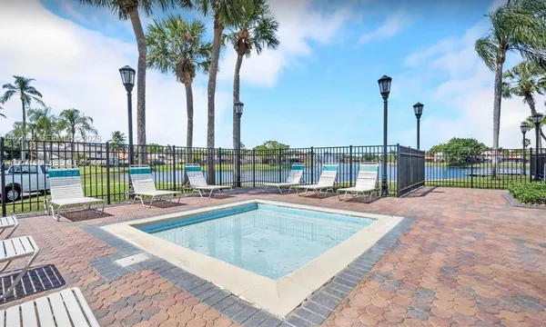 a view of swimming pool with outdoor seating and plants