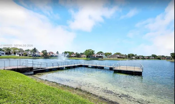 a view of a lake with houses in the back