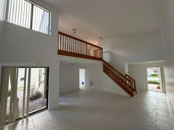 a view of staircase with white walls and railing