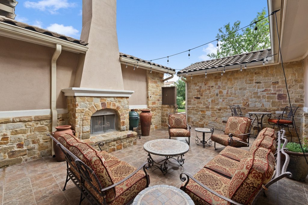 109 Largo Cove Austin, TX 78734 - Photo 40 of 40 An inviting outdoor fireplace and patio area, perfect for entertaining.