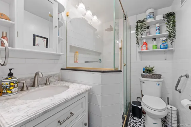 a bathroom with a sink toilet and shower