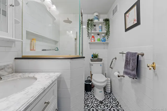 a bathroom with a sink mirror vanity and toilet