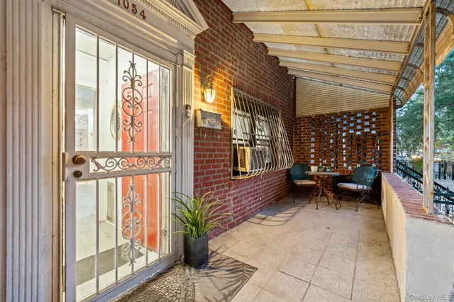 a view of a house with a yard and sitting area