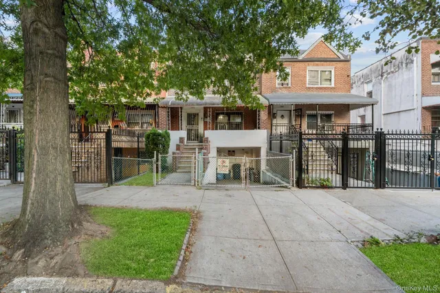 a living room with furniture a flat screen tv and kitchen view