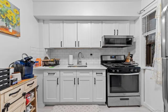 a kitchen with stainless steel appliances and a refrigerator