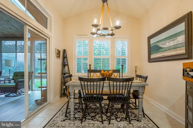 a view of a house with a patio and a yard