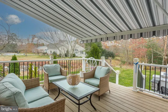 a spacious bathroom with a granite countertop sink a toilet a mirror and a shower