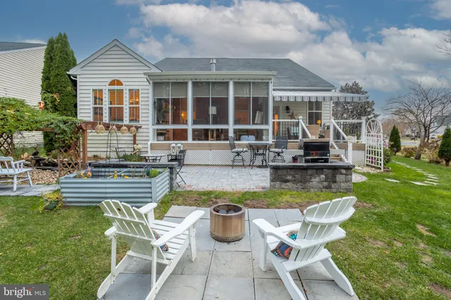 a bathroom with a granite countertop sink a toilet a mirror and shower