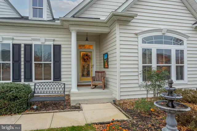 a living room with fireplace furniture and a rug