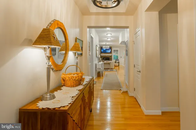 a living room with stainless steel appliances kitchen island granite countertop furniture and a wooden floor
