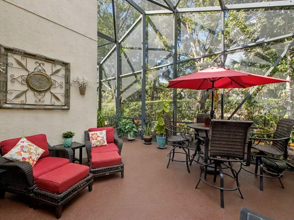 a patio with a table and chairs under an umbrella