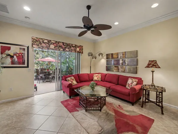 a living room with furniture a rug and a chandelier