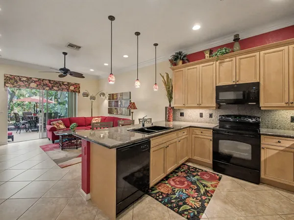 a kitchen that has a lot of cabinets in it and appliances