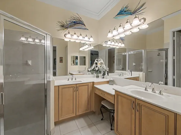 a spacious bathroom with a sink a large mirror and a shower