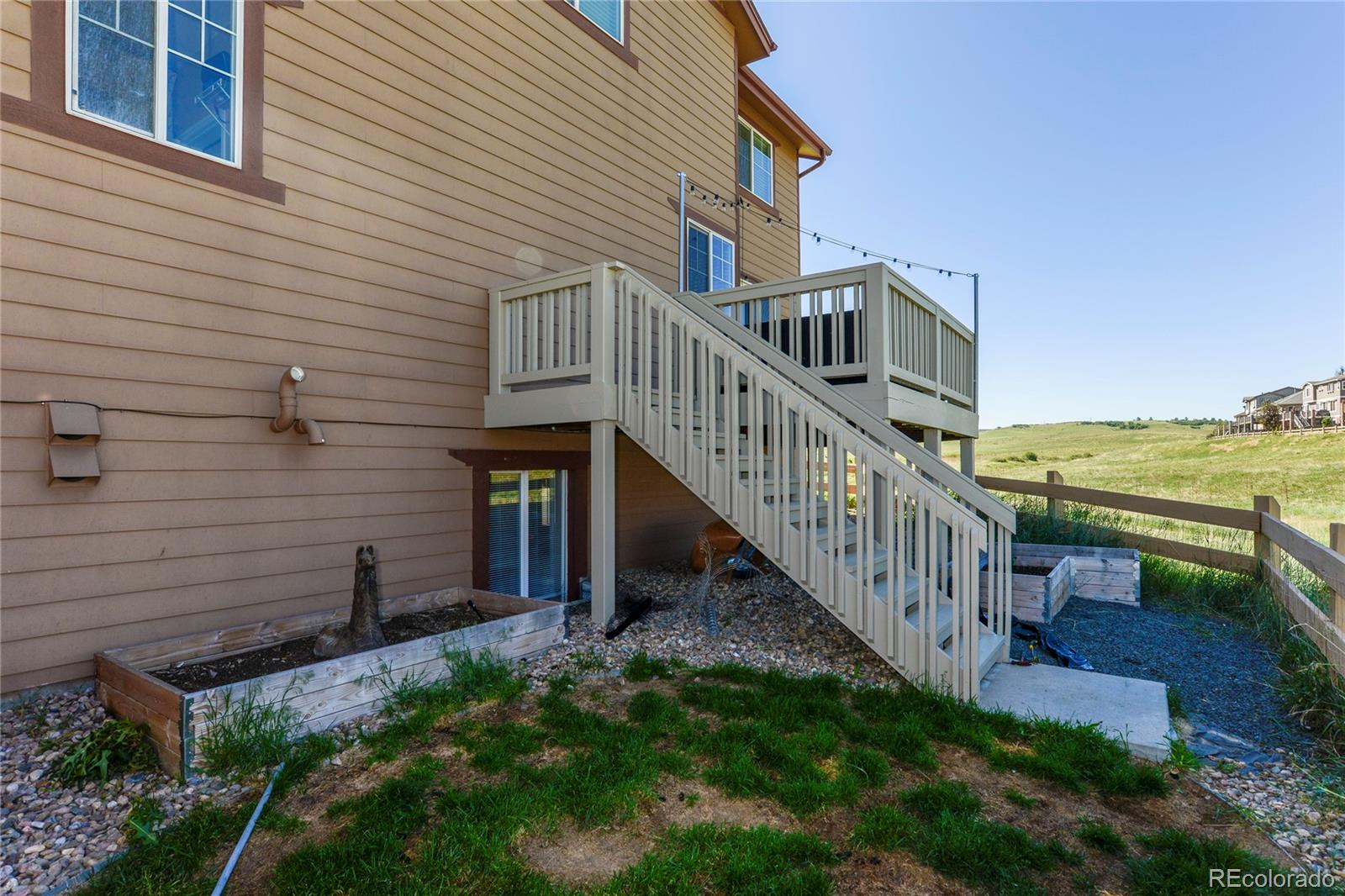 10926 Towerbridge Road Highlands Ranch, CO 80130 - Photo 28 of 34 a view of a house with backyard and porch