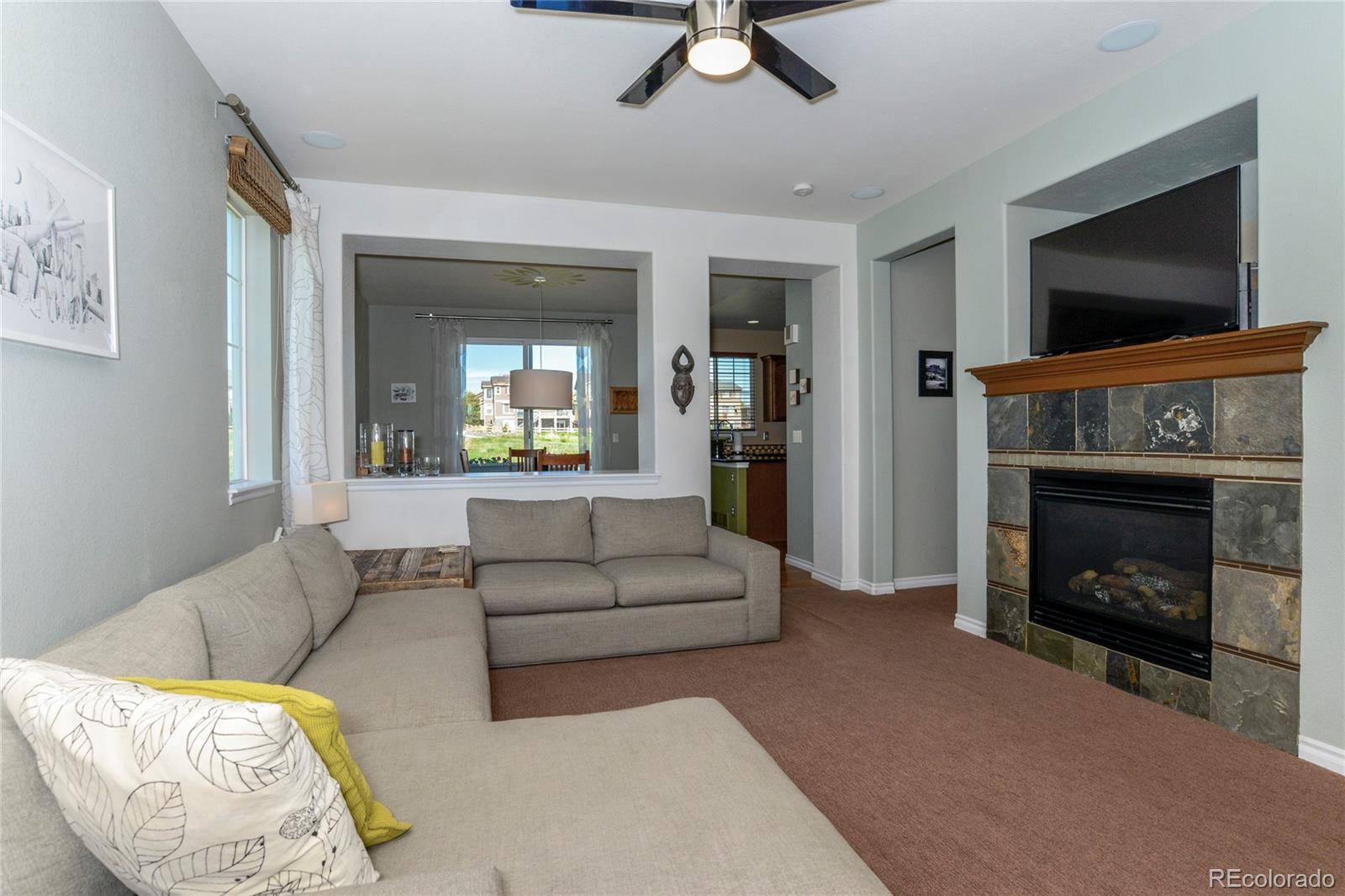 10926 Towerbridge Road Highlands Ranch, CO 80130 - Photo 4 of 34 a living room with furniture and a fireplace