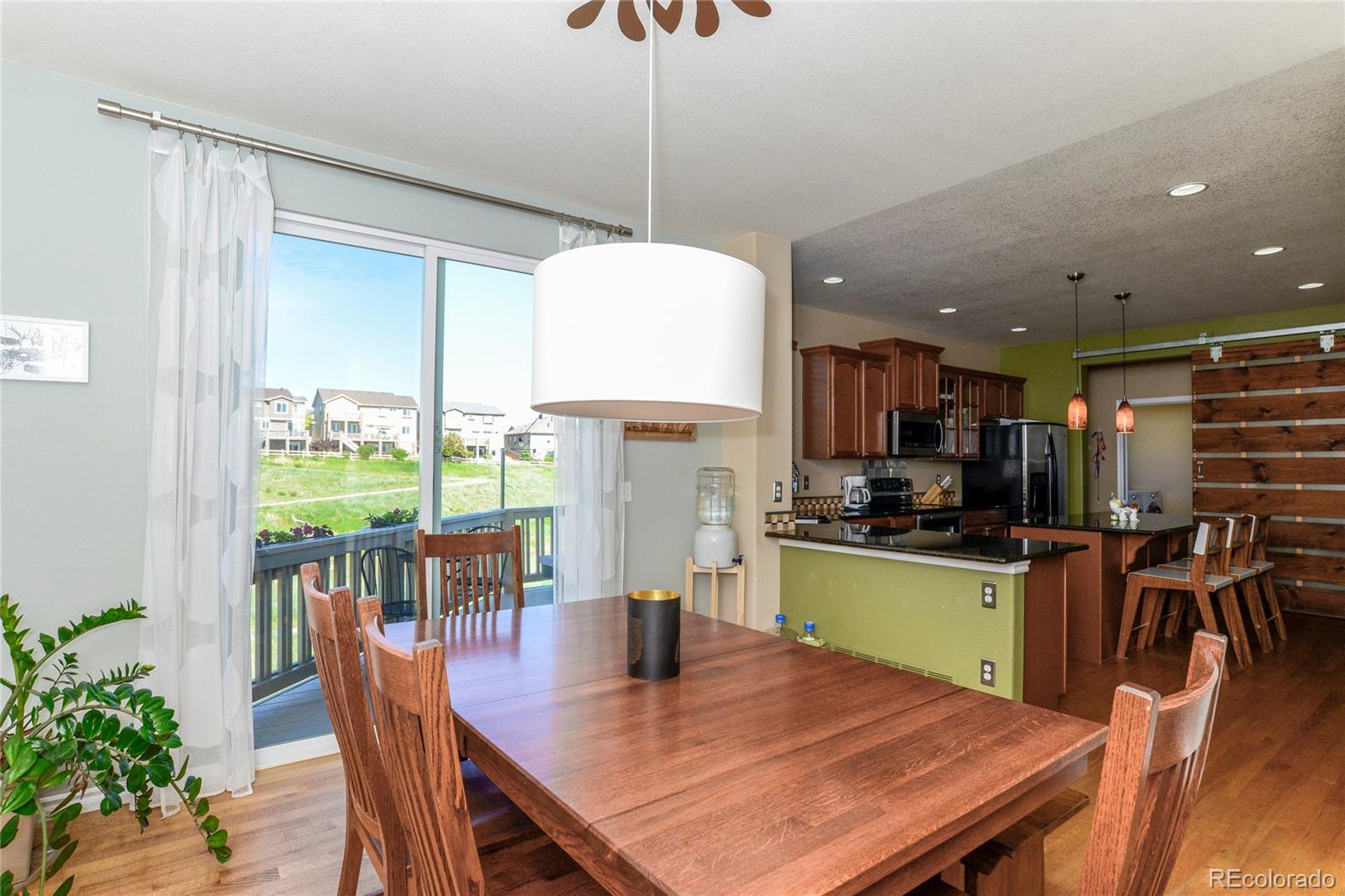 10926 Towerbridge Road Highlands Ranch, CO 80130 - Photo 8 of 34 a kitchen with a table and chairs in it