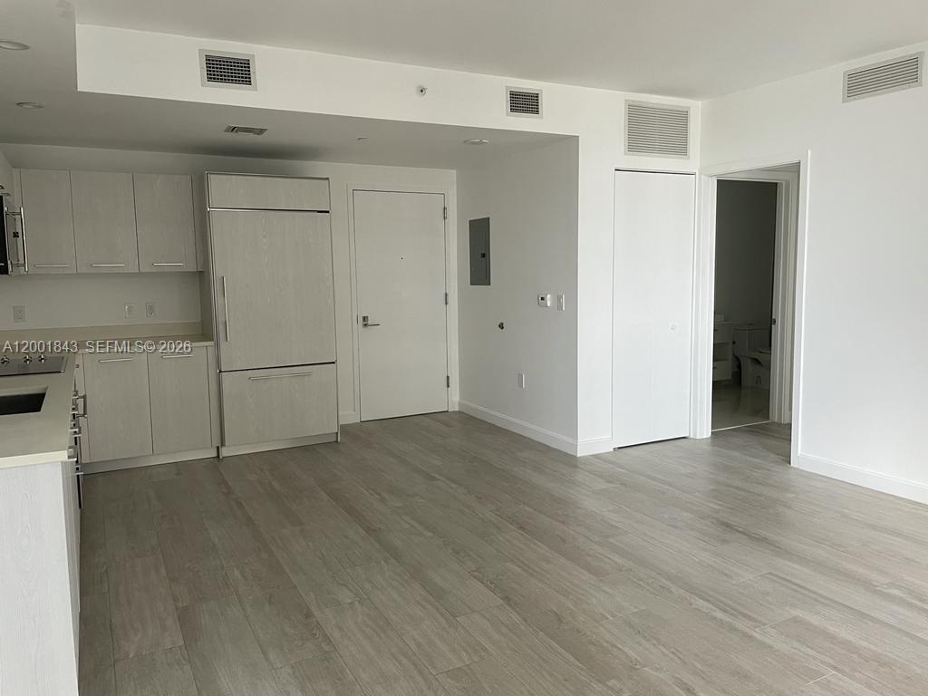 55 Southwest 9th Street, Unit 3102 Miami, FL 33130 - Photo 4 of 13 a view of a livingroom with wooden floor