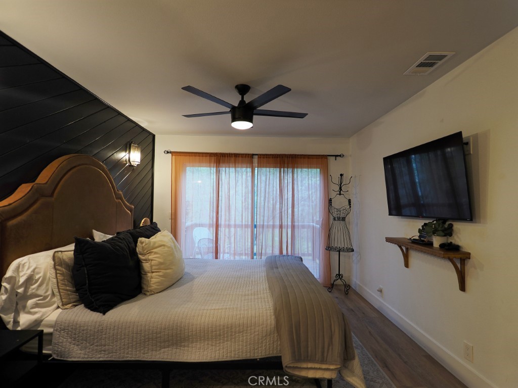 28596 North Bay Road Lake Arrowhead, CA 92352 - Photo 50 of 69 a bedroom with a large bed and a flat tv screen on dresser