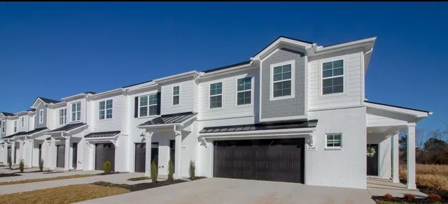 a front view of a house with a garage