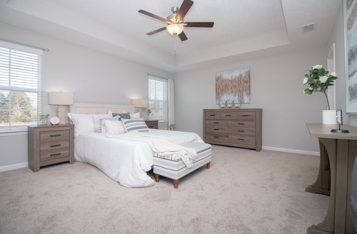 4216 Spyglass Drive Murfreesboro, TN 37127 - Photo 2 of 9 a spacious bedroom with a bed a dresser and a chandelier