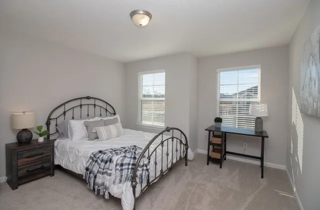 a bed room with a bed and a chair