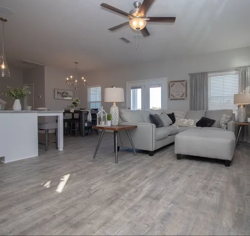 a living room with furniture and a dining table
