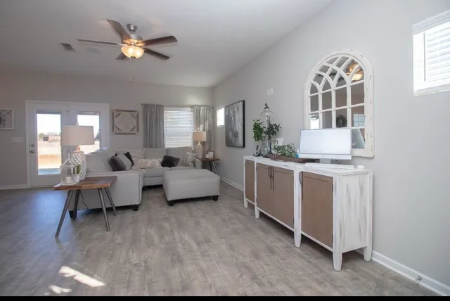 a living room with furniture and a chandelier