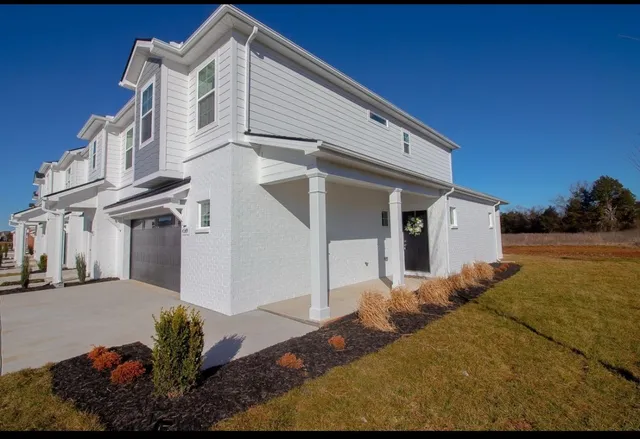 a front view of a house with a yard