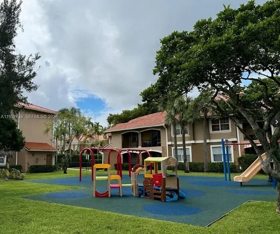 a living room with furniture a chandelier and a large window